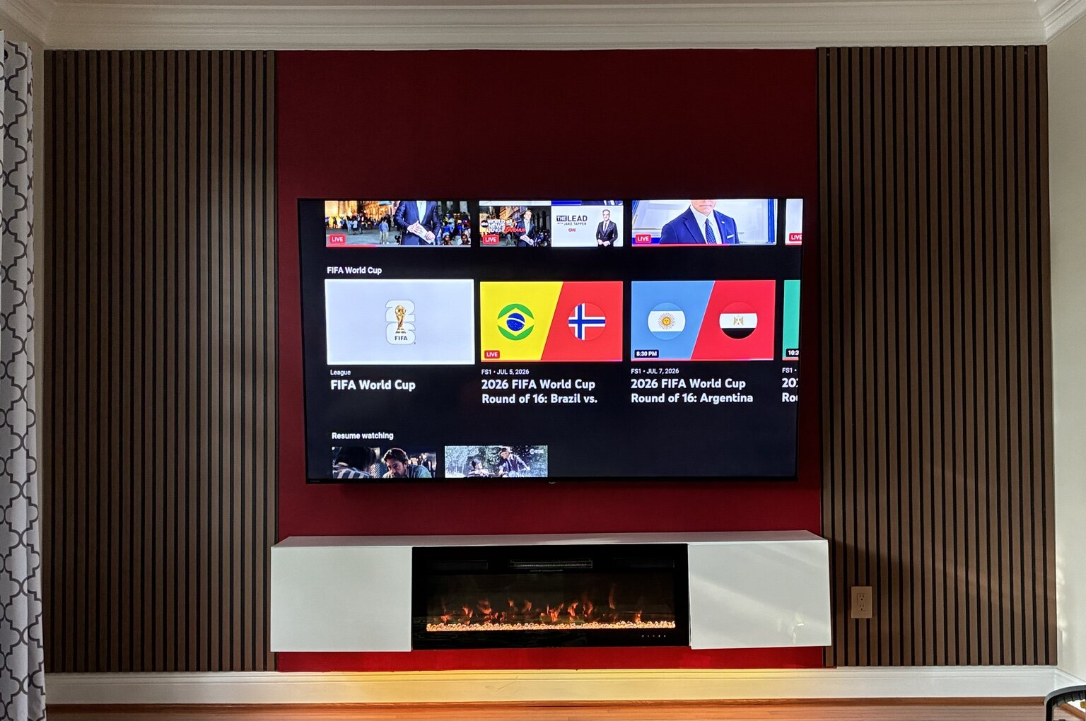 TV feature wall with wood slat panels and fireplace